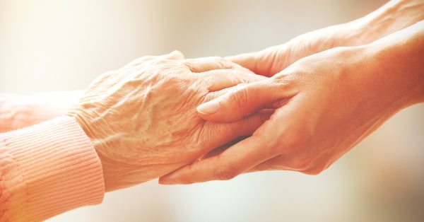 Lorraine Poulos Home Care Training Two people holding hands